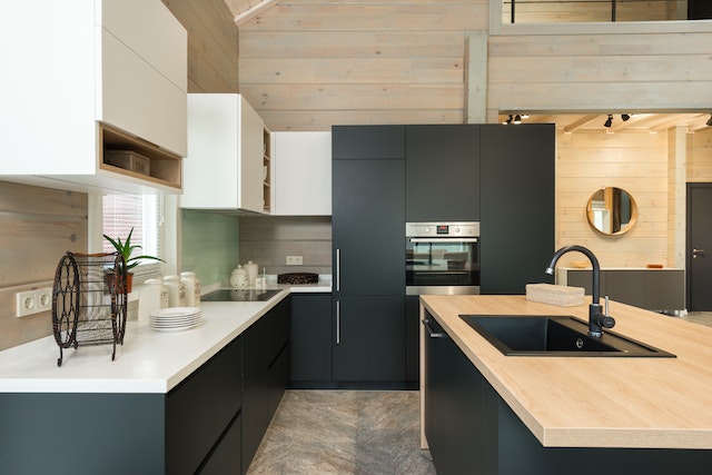 kitchen with light wood counters, darker lower cabinets and white upper storage space